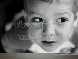 Close up photo of small child's face, the child is directing its eyes sideways, as if suspicious